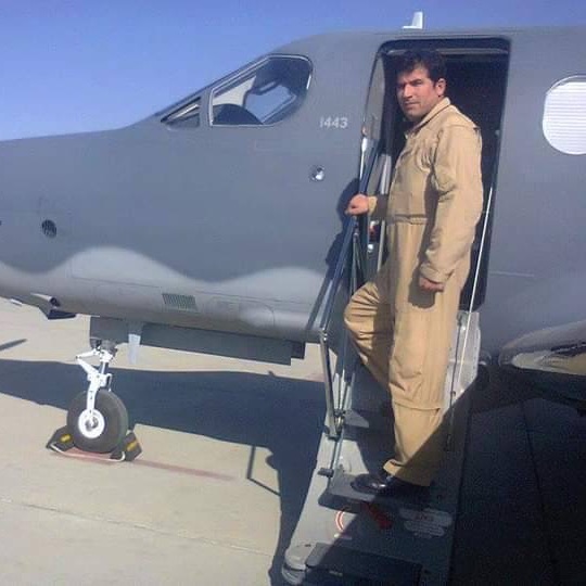 Sharifi standing on the stairs of a plane